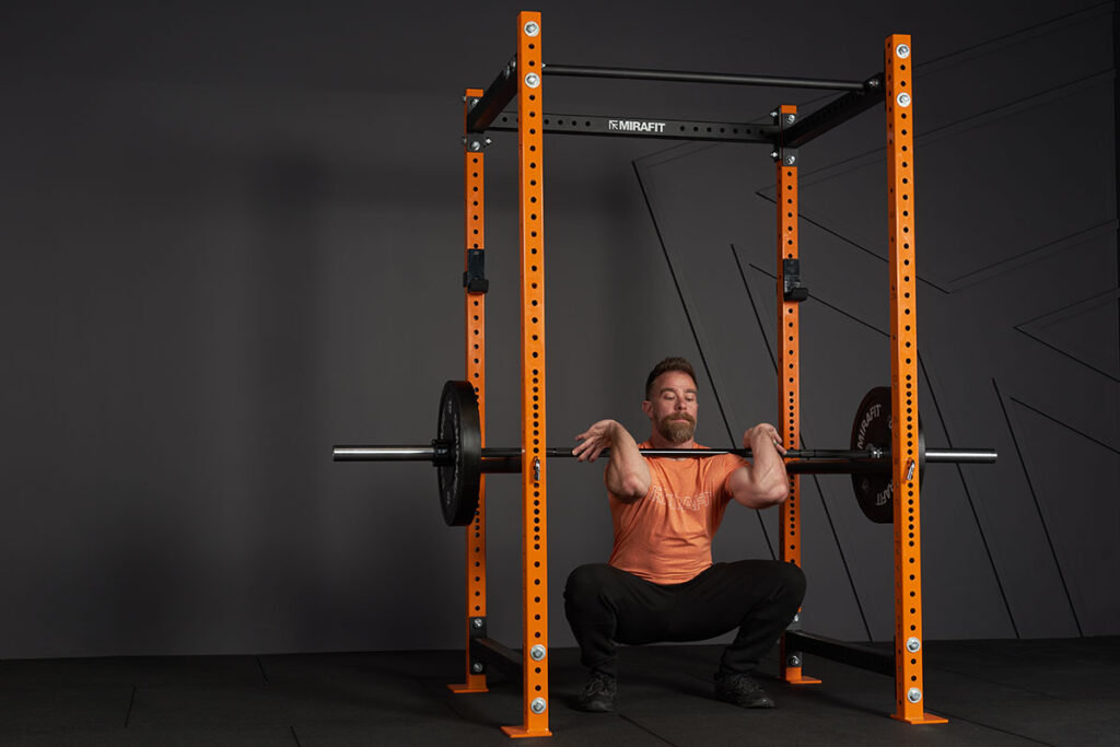 Man doing a Pin Squat in a Mirafit M3 Power Rack