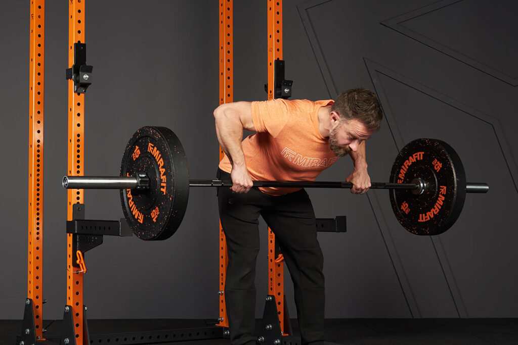 Barbell Bent Over Row Man doing a barbell bent over row in a Mirafit M3 Half Rack