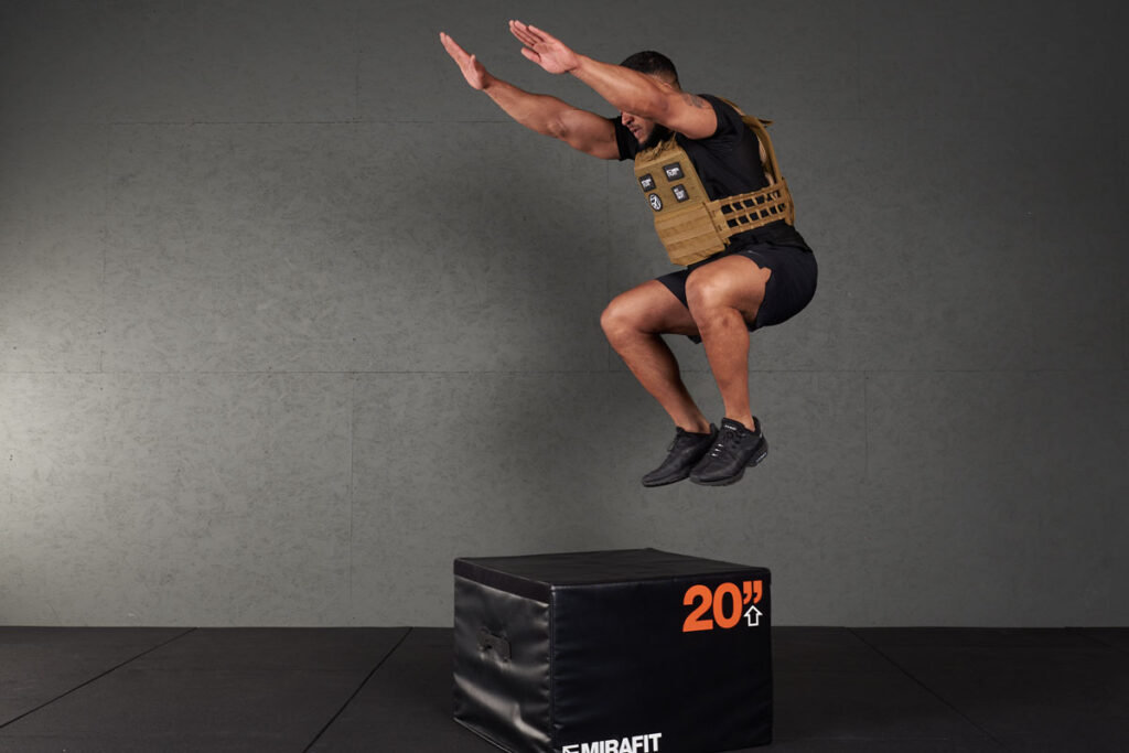 Box Jump Man doing a box jump with a Mirafit Tactical Weight Vest