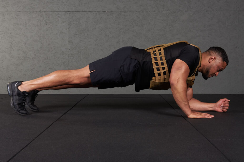 High plank to low plank Man doing a high plank to low plank with a Mirafit Tactical Weight Vest