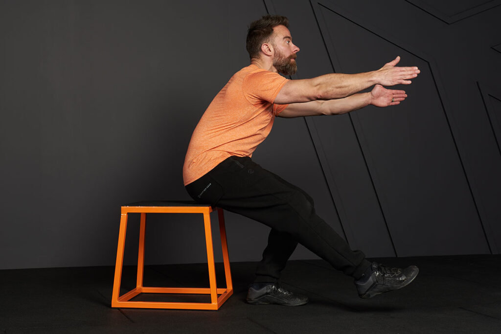 Man doing a single leg squat to box with a Mirafit Steel Plyo Jump Box.