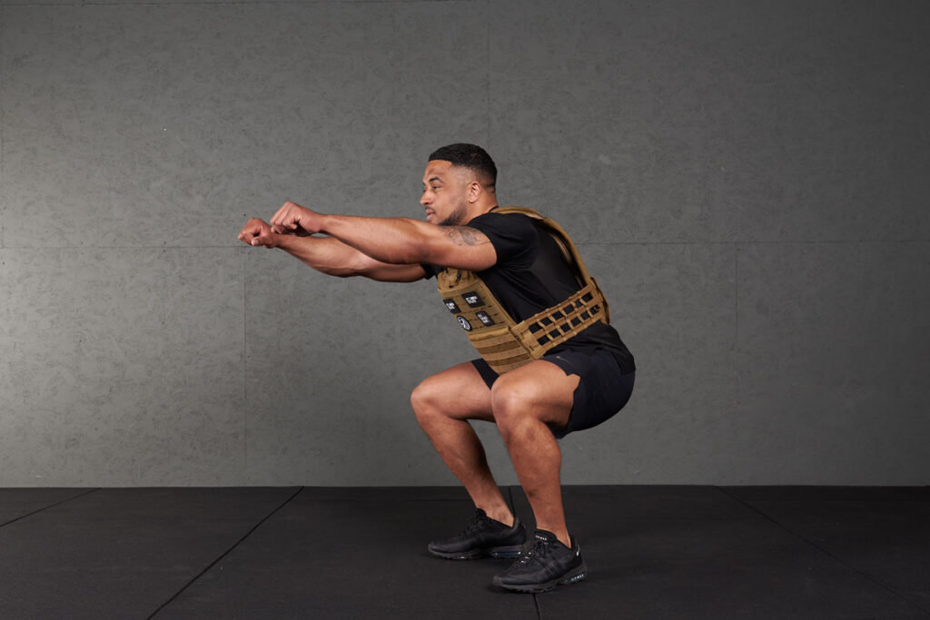 Squat Man doing a squat with a Mirafit Tactical Weight Vest