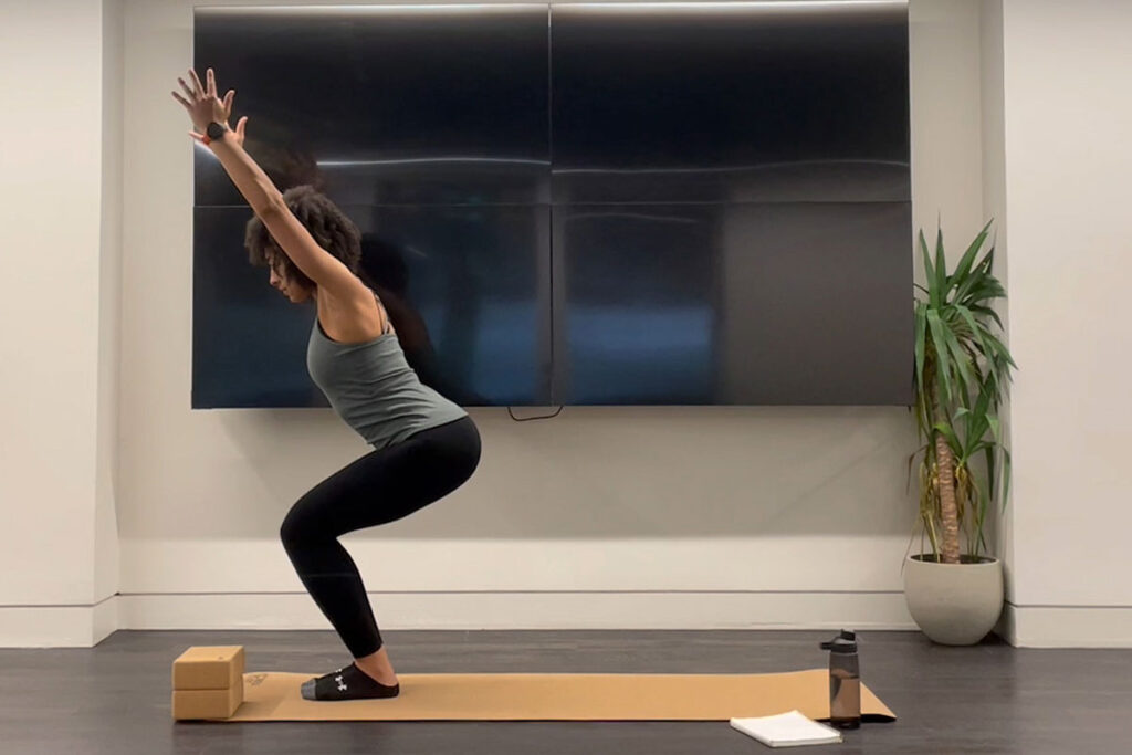 Chair Pose Woman doing the yoga chair pose
