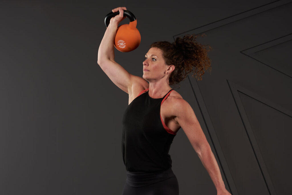 Kettlebell Thruster Woman doing a kettlebell thruster with a Mirafit 16kg Kettlebell