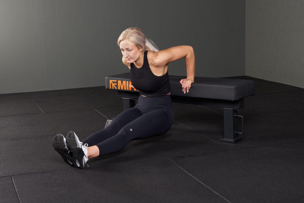 Tricep Dip Woman doing a tricep dip on a Mirafit Flat M3 Weight Bench