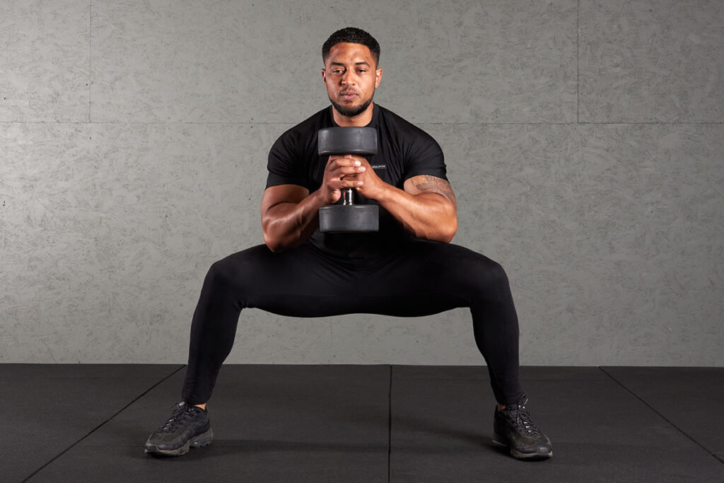Man Doing a Sumo Squat with a Mirafit Dumbbell
