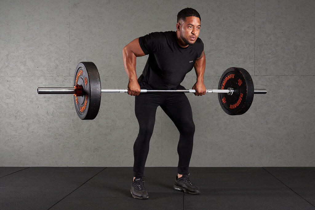 Bent Over Barbell Row Man doing a bent over barbell row with Mirafit 25kg bumper plates