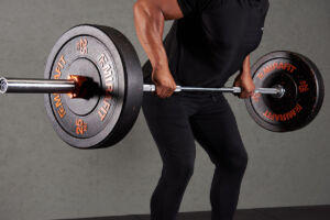 Man doing a barbell row with Mirafit 25kg Bumper Plates