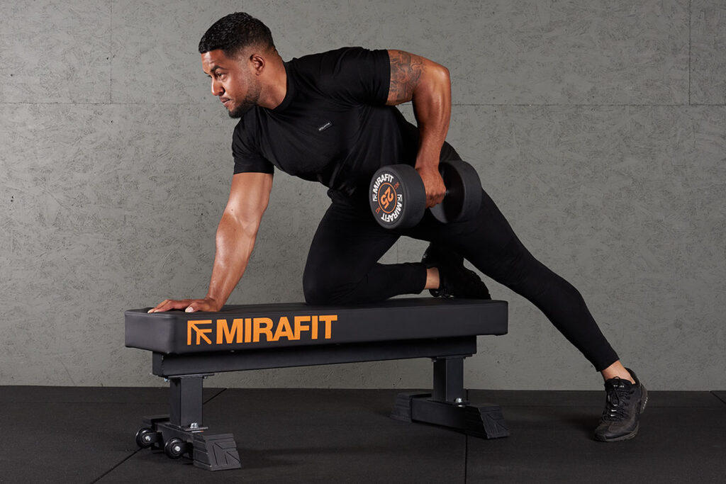 Bench Assisted Dumbbell Row Man doing a bench assisted dumbbell row with a Mirafit 25kg Dumbbell