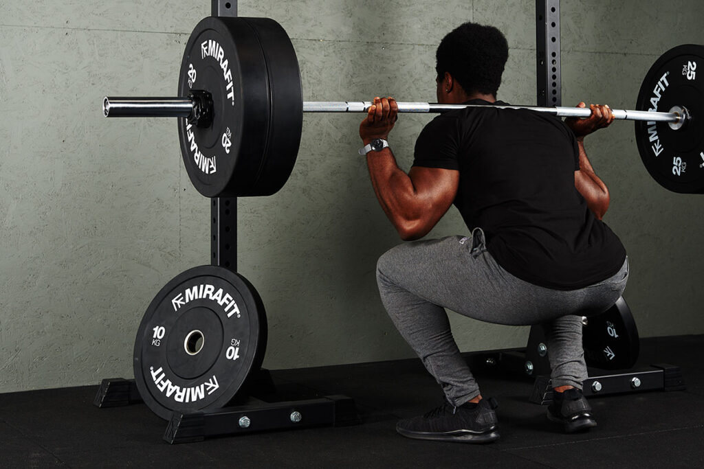 Man doing a medium drop set with Mirafit Olympic Barbell