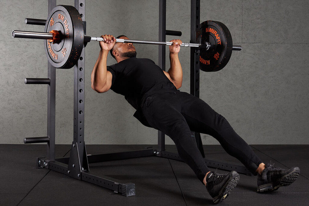 Reverse Row Man doing a reverse row with Mirafit 25kg bumper plates
