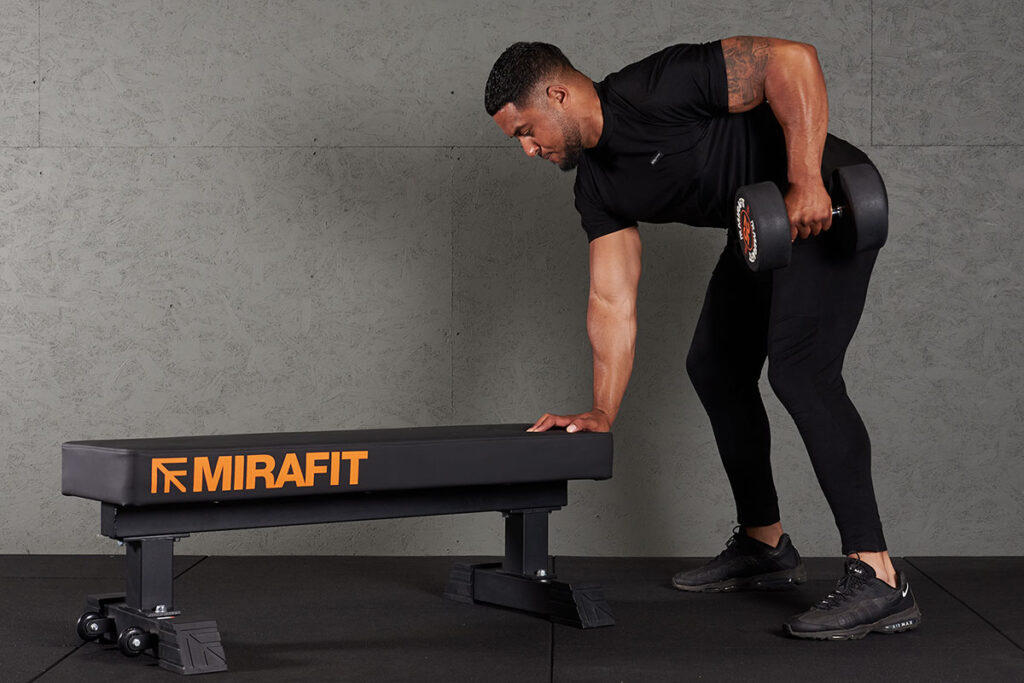 Three Point Dumbbell Row Man doing a three point dumbbell row with a Mirafit 25kg Dumbbell