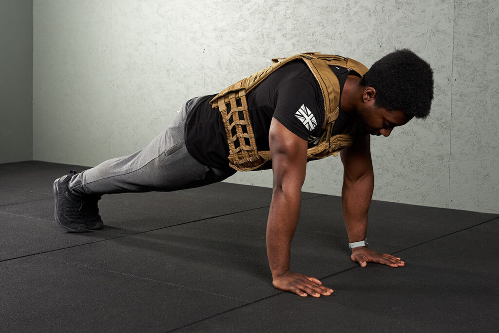 Man doing a blank wearing a Mirafit Tactical Weight Vest