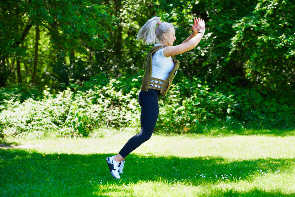 Burpee Broad Jumps Woman doing a burpee broad jump in a Mirafit Tactical Weight Vest