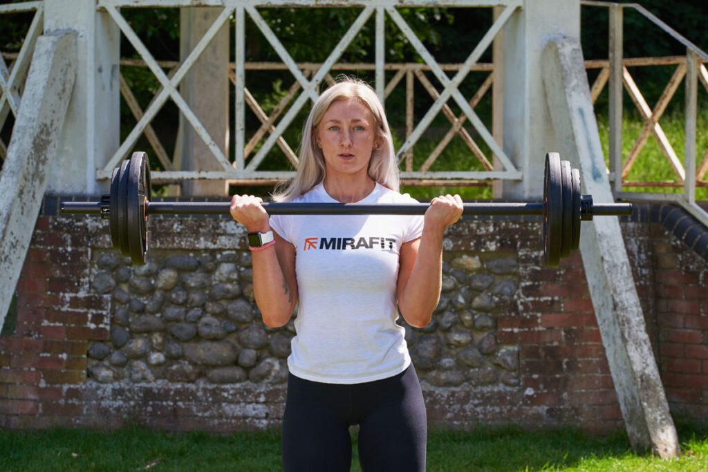 Bicep Curl Woman doing a bicep curl with a Mirafit Studio Pump Set