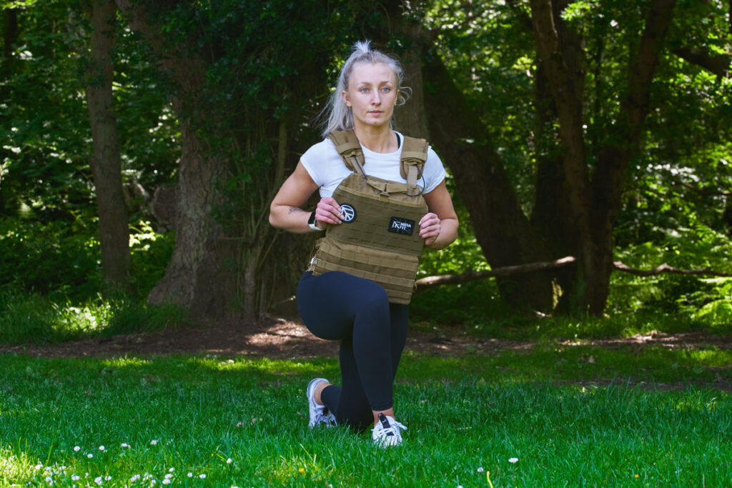 Curtsy Lunge Woman doing a curtsy lunge in a Mirafit Tactical Weight Vest