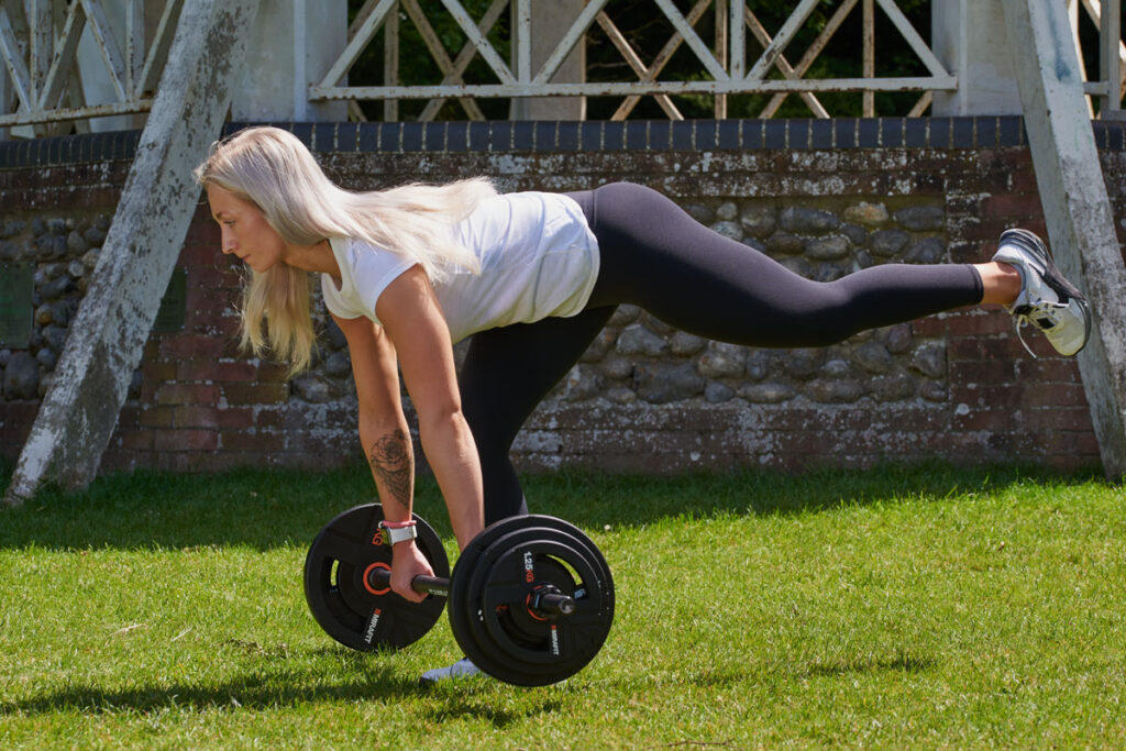 Single Leg Deadlift Woman doing a single leg deadlift with a Mirafit Studio Pump Set