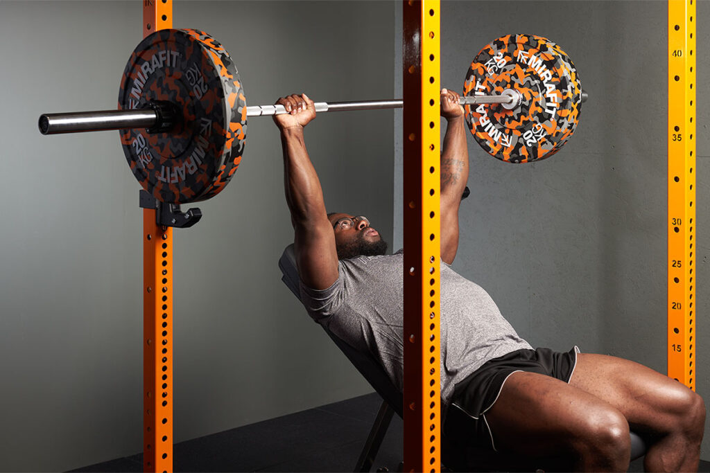 Man doing an incline bench press on a Mirafit M3 Power Rack