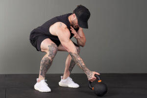 Man Using a Mirafit Cast Iron Kettlebell
