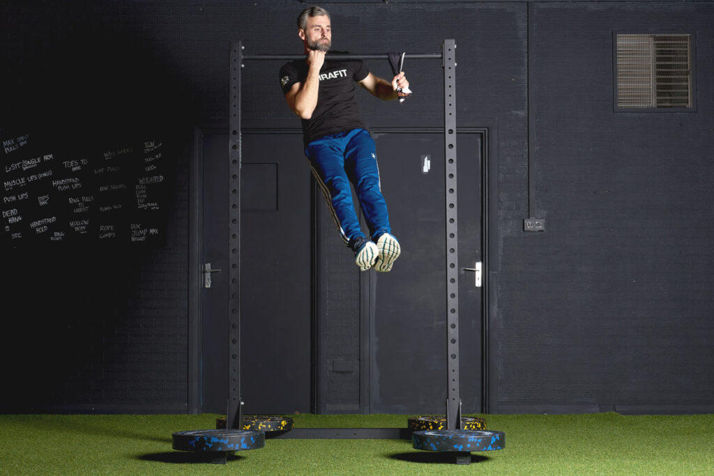 Assisted One Arm Chin Up Assisted One Arm Chin Up on a Mirafit M210 Half Power Rack