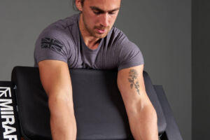 Man Using a Mirafit M3 Preacher Curl Bench