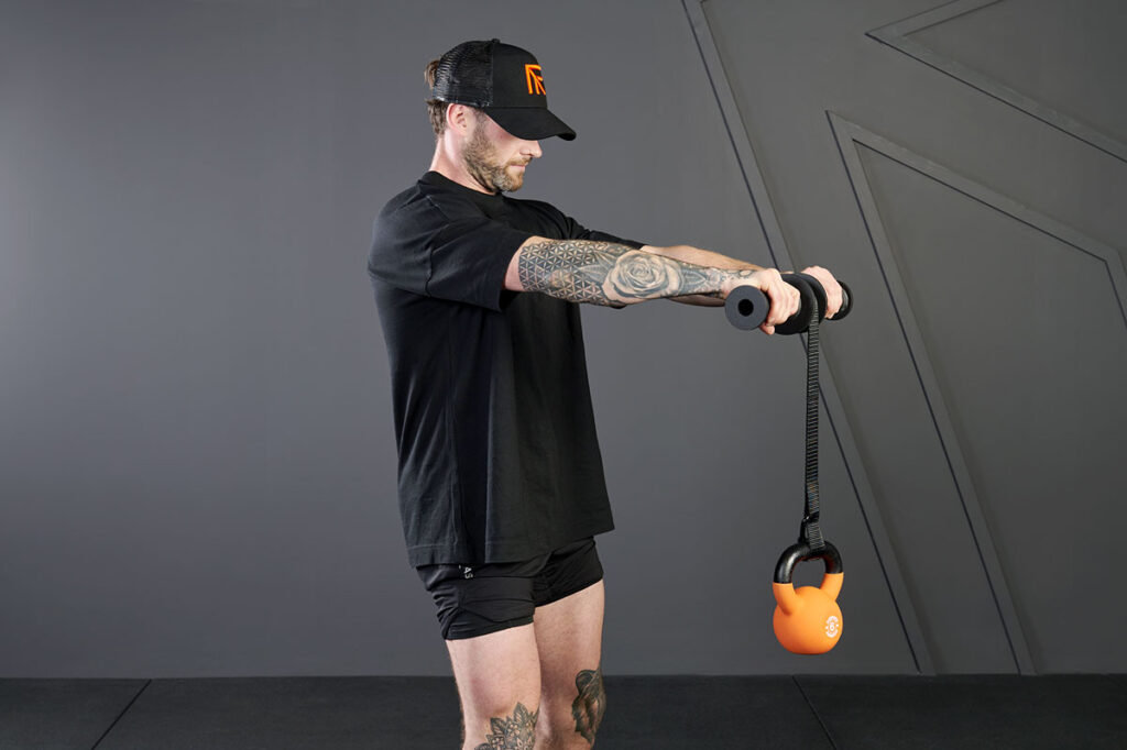 Man using a Mirafit Wrist Roller with a Mirafit Soft Touch Kettlebell