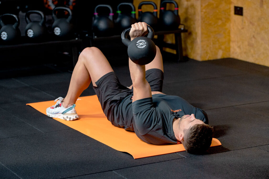 One Arm Floor Chest Press One Arm Floor Chest Press with a Mirafit 20kg Kettlebell