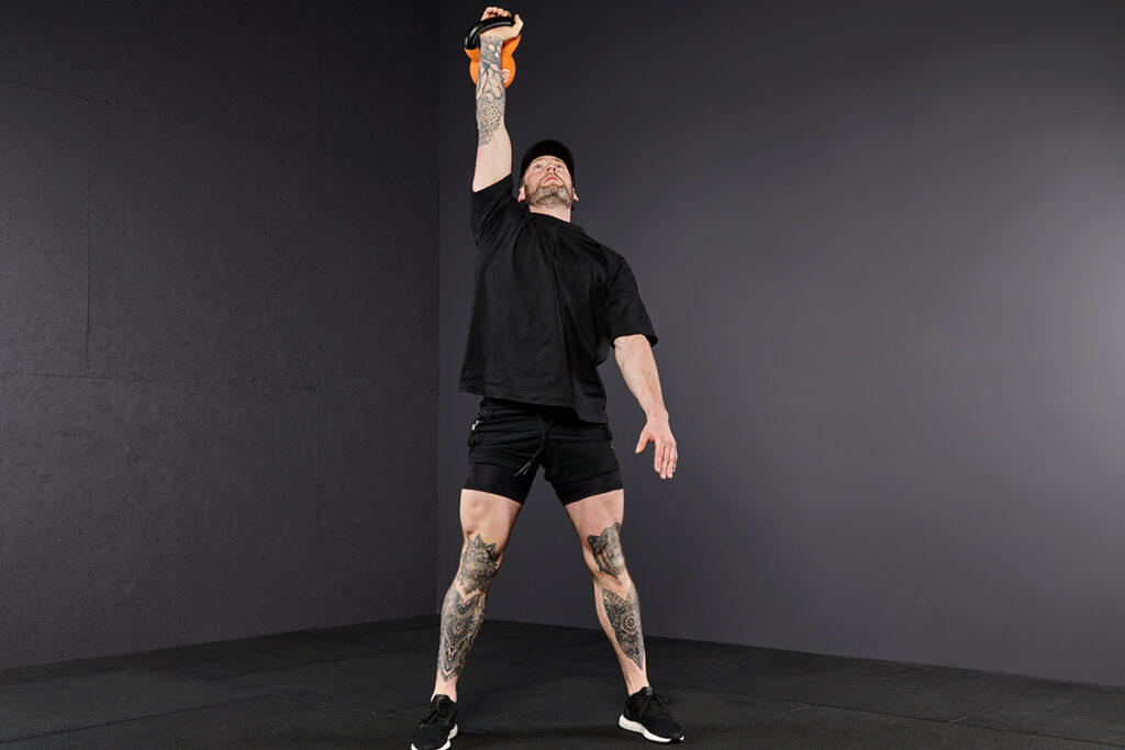 Half Kneeling Overhead Lunge to Standing Mirafit Kettlebell Turkish Get Up Step 7- Half Kneeling Overhead Lunge to Standing