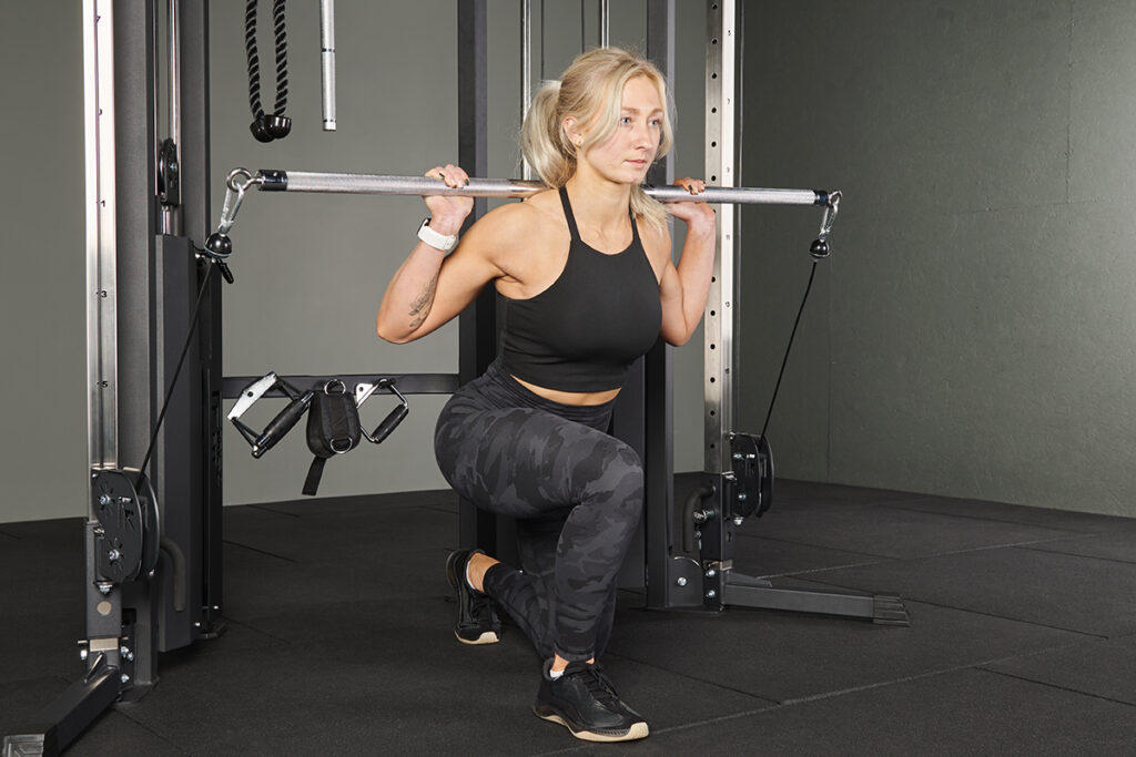 Long Bar Split Squats Long Bar Split Squats in a MIrafit Functional Trainer