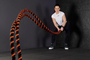 Woman using Mirafit Battle Ropes