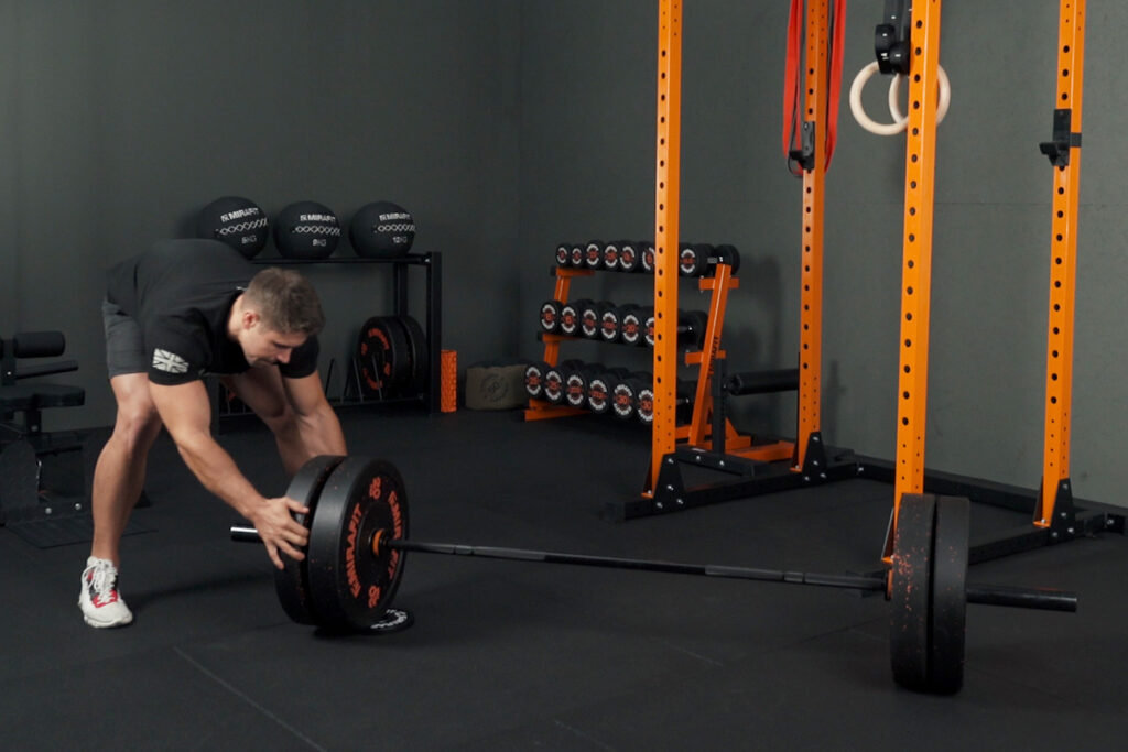 Mirafit Calibrated Cast Iron Weight Plates Gareth Sapstead unloading a Mirafit Barbell