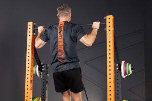 Man doing a pull up on a Mirafit M4 Half Rack