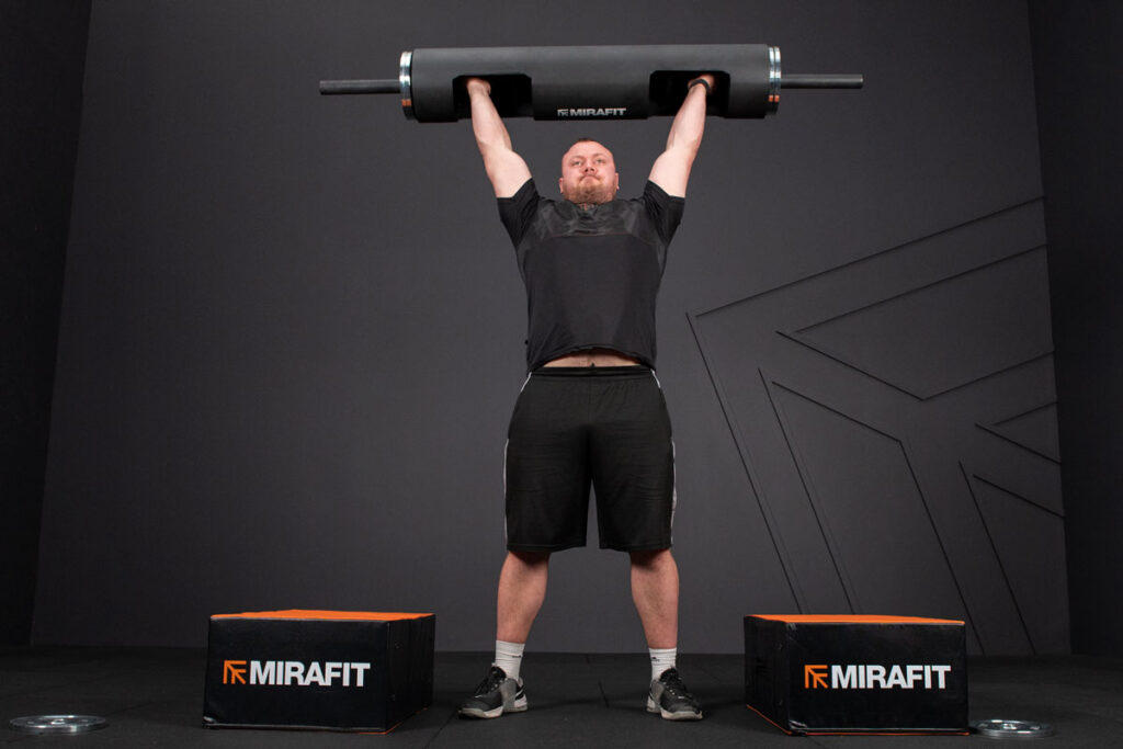 Adam Bishop using Mirafit Strongman Log