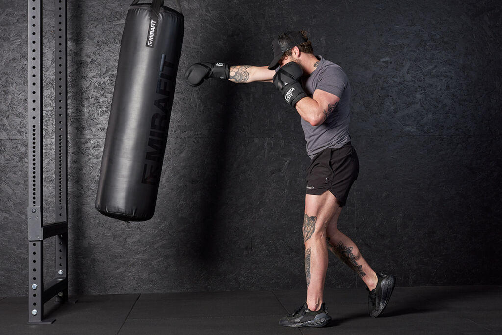 Man punching a Mirafit Hanging Punch Bag