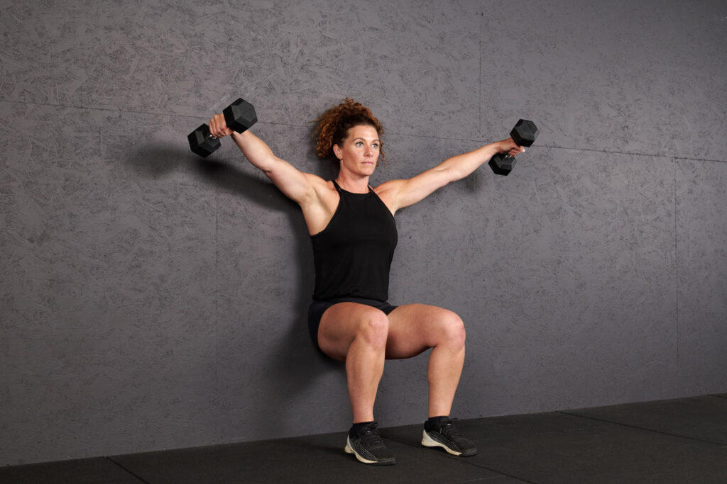 Wall sit with lateral raise using Mirafit Hex Dumbbells