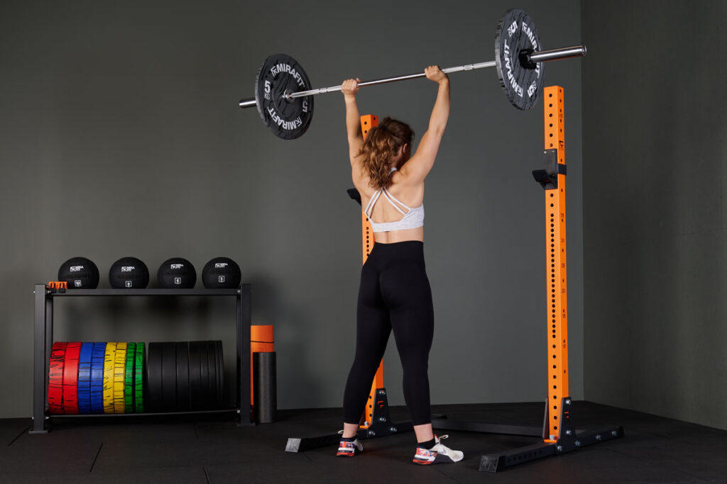 Shoulder press using Mirafit Marbled Bumper Plates