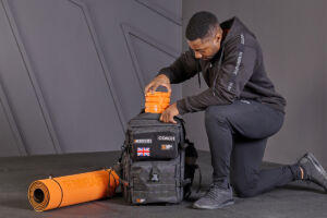 Man unpacking the Mirafit Personal Trainer Package