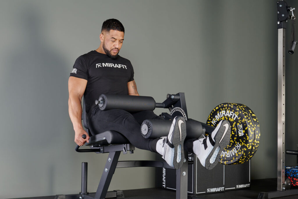 Man using Mirafit Leg Curl and Extension Machine