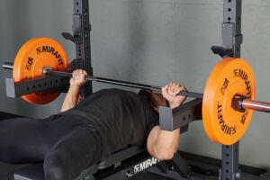Pin press with Mirafit Olympic Bumper Plates