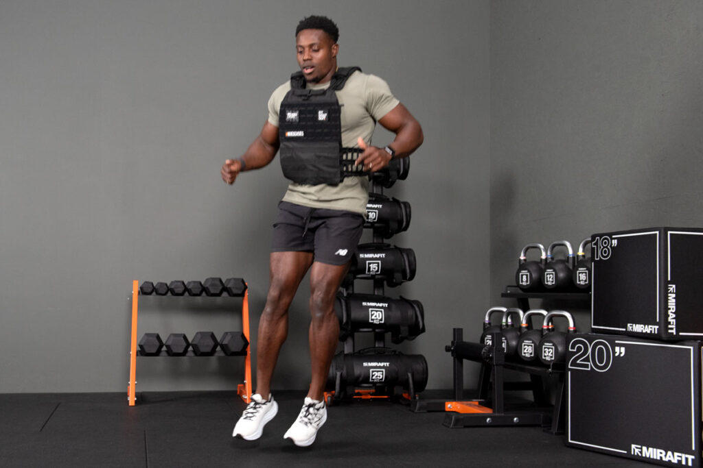 Mirafit Tactical Weight Vest Squat jumps wearing a Mirafit Tactical Weight Vest