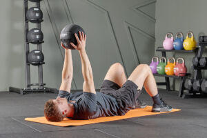Floor press using Mirafit Medicine Ball