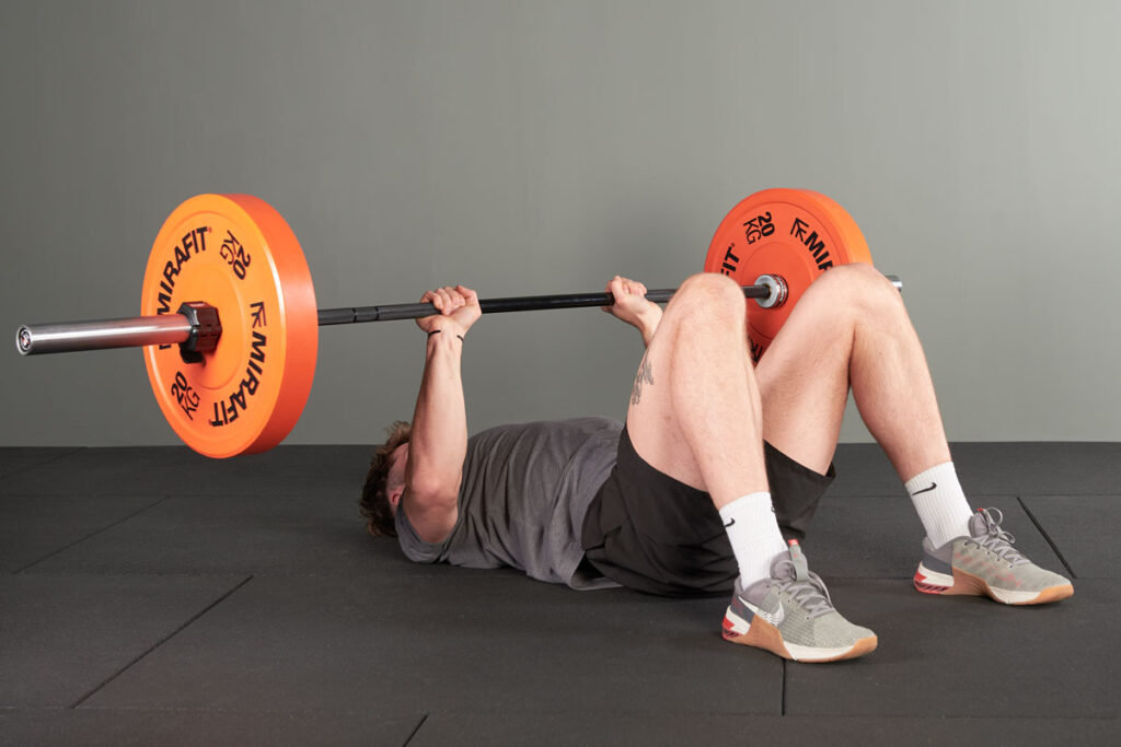 Floor press using Mirafit Olympic Bumper Plates