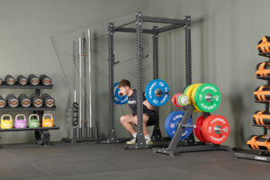 Man squatting in a Mirafit Commercial Gym