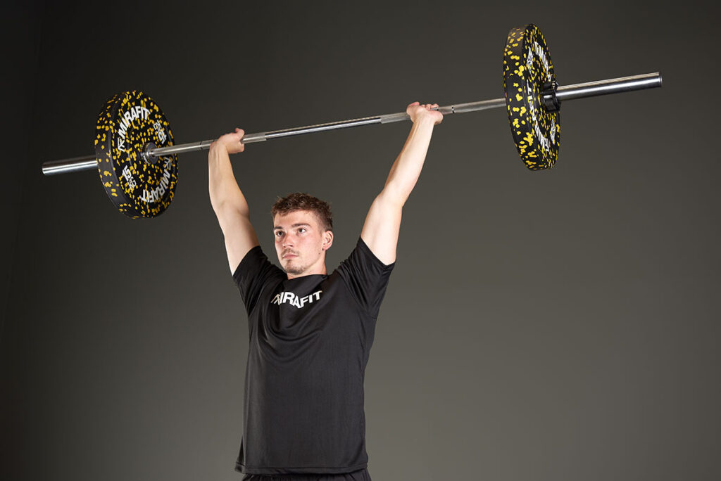 Mirafit Barbell held overhead in a Clean and Jerk
