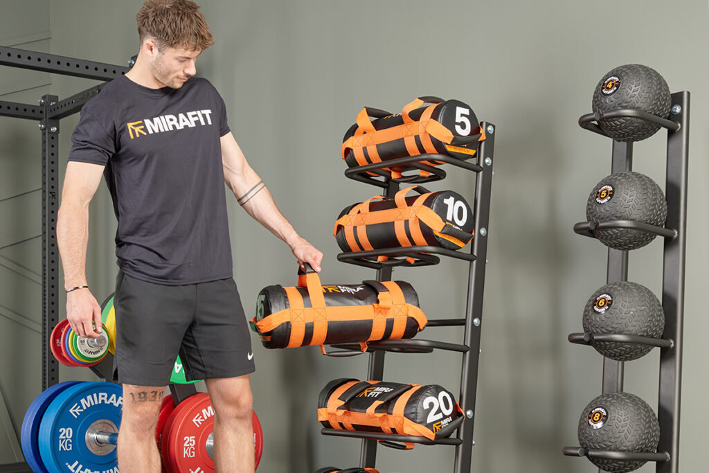 Mirafit Gym Sandbag/Power Bag Storage Rack Man unracking a power bag on a Mirafit Gym Sandbag/Power Bag Storage Rack