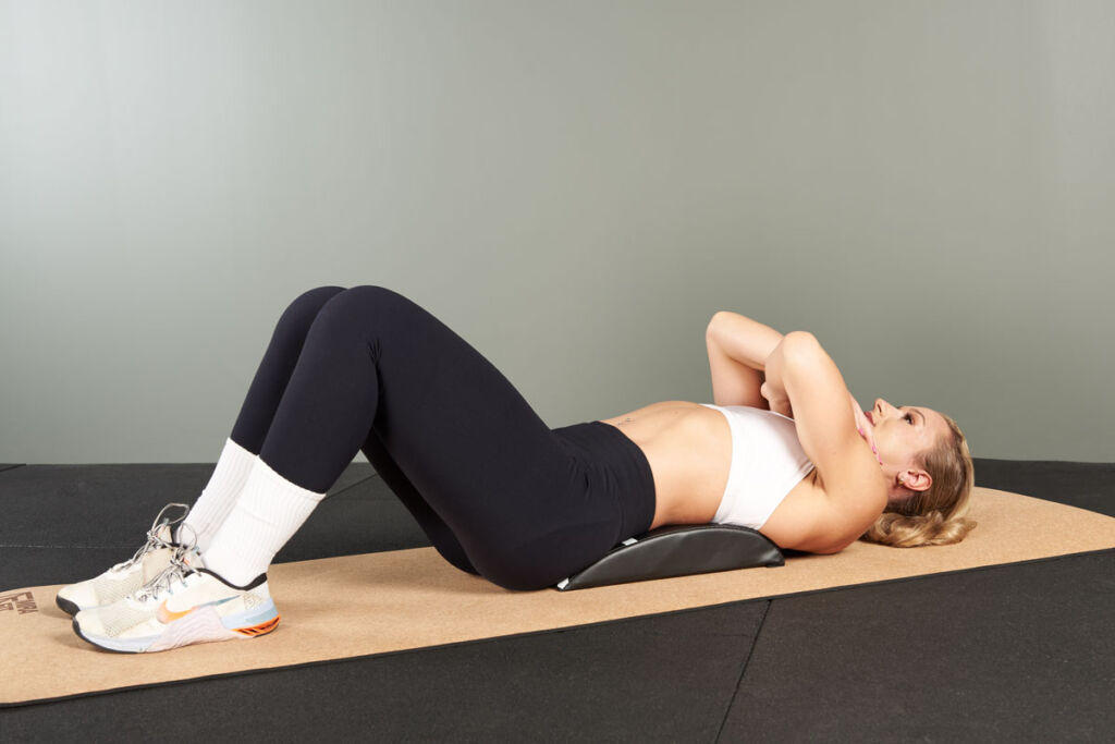 Woman using a Mirafit Ab Pad Mat