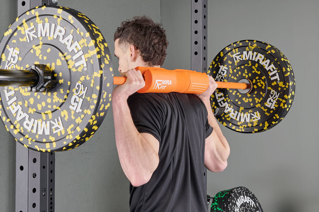 Man squatting using a Mirafit Barbell Squat Pad