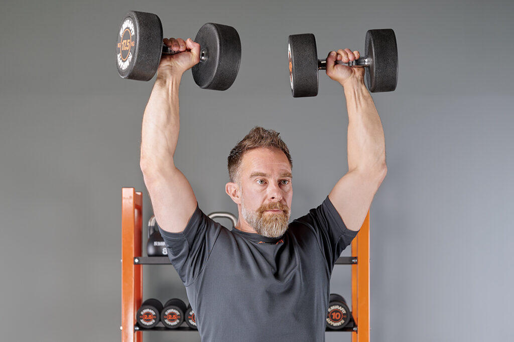 shoulder press using Mirafit Rubber Dumbbells
