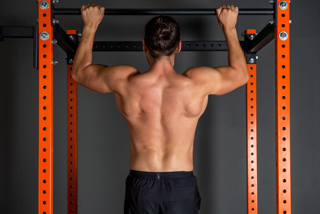 Mirafit M3 Power Rack man using Mirafit Pull Up Bar on Rack