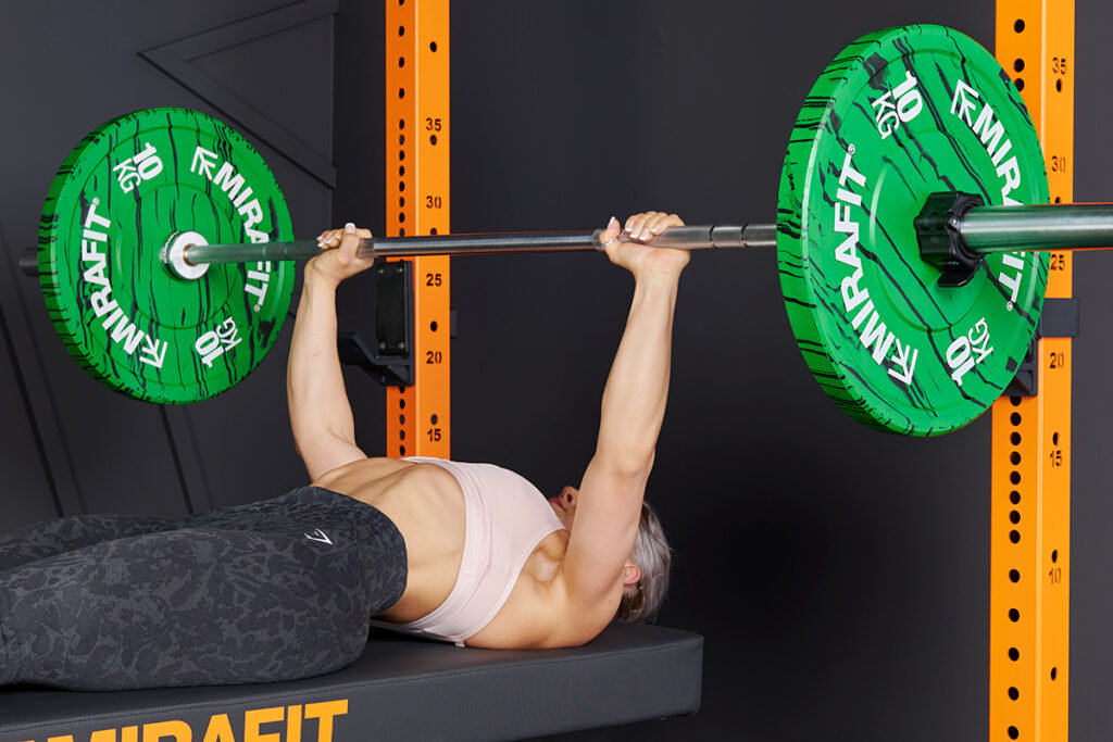 Bench press using Mirafit Marbled Bumper Plates
